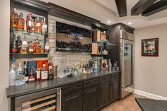 a home bar with liquor bottles on the shelves