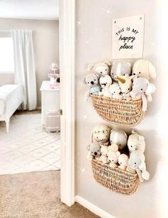 two baskets filled with stuffed animals on top of a wall next to a bed in a bedroom