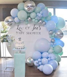 a baby shower is decorated with balloons and cake