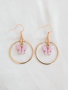 Pink Butterfly Charm Drop Earrings, Pink Drop Earrings With Butterfly Charm, Pink Butterfly Charm Dangle Jewelry, Butterfly Charm Hoop Jewelry Gift, Pink Dangle Jewelry With Butterfly Charm, Dainty Pink Hypoallergenic Hoop Earrings, Dainty Pink Hoop Earrings, Trendy Butterfly Hoop Earrings As Gift, Trendy Hoop Earrings With Butterfly Charm As Gift