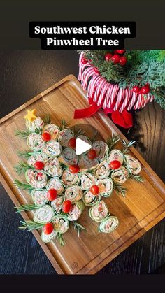 a wooden cutting board topped with food on top of a table