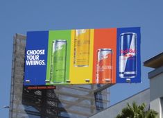 an advertisement for red bull is shown on the side of a building in front of palm trees