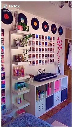 there is a room with many records on the wall and shelves in front of it