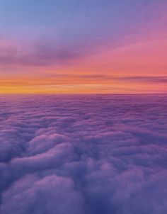 the sky is filled with clouds as the sun sets over the horizon in this photo