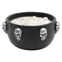 a bowl filled with liquid and skulls on it