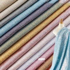 several different colors of fabric on a mannequin's dummy, including blue and pink