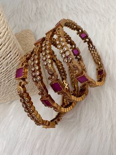 Traditional Bangles comes in set of 4Color : Matte GoldSize : Size : 2.4Stones : CZ Red Stone Red Stone Work Bangle For Diwali, Red Stone Work Bangle Jewelry, Red Stone Bangles In Gold, Heavy Red Bangle, Red Adjustable Traditional Bangle, Traditional Bangles, Gold Bangle Set, Bangle Set, Red Stone