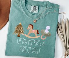 This cute Christmas Sweatshirt is perfect for a Pregnancy Announcement in the Christmas Season ♥  ♥ PRODUCTION TIME: 1-5 days (Usually 2-3 days) ♥ SHIPPING TIME: 2-5 days (Usually 3 days) ♥PRODUCT DESCRIPTION: Comfort Colors 1717 Super soft cotton and excellent quality print makes. Made with medium fabric (6.1 oz/yd² (206.8 g/m consisting of high quality, 100% ring-spun US cotton for long-lasting comfort. Runs true to size Comfort Colors introduces its garment-dyed t-shirt; a fully customizable Christmas Maternity Shirt, Pregnant Shirt, Funny Pregnancy Shirts, Funny Pregnancy, Christmas Pregnancy, Pregnancy Announcement Shirt, Pregnancy Humor, Pregnancy Shirts, Cute Christmas