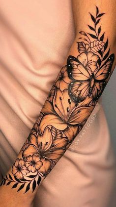 a woman's arm with flowers and butterflies on it