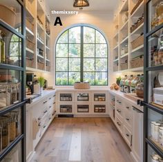 the inside of a kitchen with lots of cupboards and shelves filled with food items