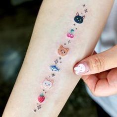 a woman's arm with tattoos on it that have animals and stars on them