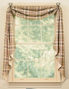 a window with a plaid curtain hanging from it's side