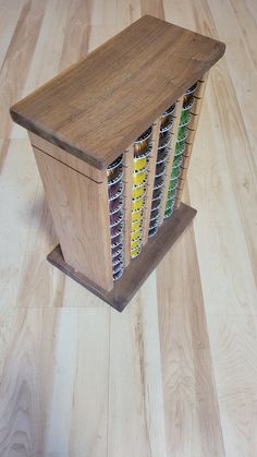 a wooden box filled with lots of different types of condiments on top of a hard wood floor