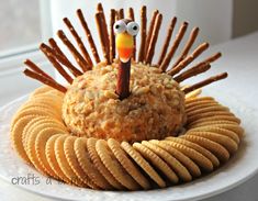 a plate topped with crackers and a turkey made out of crackers on top of it