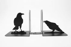 two bookends with black raven silhouettes sitting on top of each other and the words bookends black raven above them