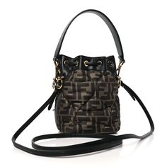 This is an authentic FENDI Silk Vitello King FF 1974 Quilted Mini Mon Tresor Bucket Bag in Tobacco and Moro. This chic shoulder bag is crafted of FF monogram in brown and black with a geometric padded design. The bag features a waist-length black calfskin leather shoulder strap and a leather top handle. The top opens to a matching fabric interior. Ff Monogram, Waist Length, Leather Top, Bucket Bag, Top Handle, Calf Skin, Fendi, Shoulder Strap, Monogram