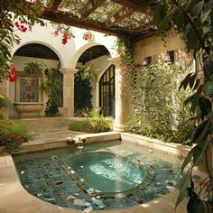 an indoor swimming pool surrounded by greenery and potted plants in a courtyard area