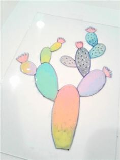 a paper cactus with pastel colors is on a white surface and it's cut out to look like an animal