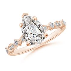 a pear shaped diamond engagement ring set in 18k rose gold with diamonds on the band