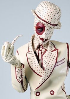 a man dressed in white and red with polka dots on his face