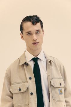 a young man wearing a jacket and tie