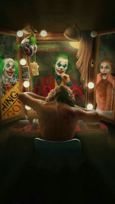 a man sitting in front of a mirror with clowns on it