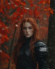 a woman with red hair and black armor standing in the woods, surrounded by leaves