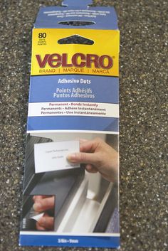 an ad for velcro on the ground with someone's hand holding a credit card