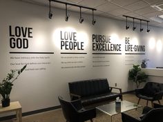 an office with black leather chairs and white walls that say love, pursue, excellence, life - giving