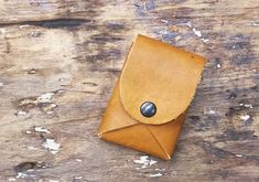 a brown leather case sitting on top of a wooden table