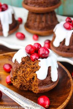 a chocolate cupcake with white frosting and pomegranates on top