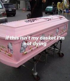 a large pink casket with hello kitty decals on it's sides and the words, if this isn't my casket i'm not dying