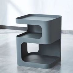 a gray shelf sitting on top of a cement floor