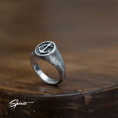 Introduce an air of timeless elegance with our Anchor Signet Ring, a rustic oxidized pinky ring that beautifully combines vintage charm with modern masculinity. Perfect as a unique men's wedding band or a thoughtful engagement and anniversary gift for your boyfriend, this striking piece features an intricate anchor design that symbolizes steadfastness and love. The rich patina provides a distinctive character, making it a conversation starter that captures the essence of adventure and authentici Round Ring With Steel Shank For Gift, Round Steel Shank Rings As Gifts, Mens Rings Wedding, Band Boyfriend, Anniversary Gifts For Your Boyfriend, Mens Wedding Bands Unique, Steampunk Rings, Oxidized Ring, Silver Certificate