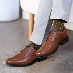 Bring true sophistication and class to your look with these cap toe oxfords. The versatile, yet traditional style of the polished synthetic uppers paired with handcrafted, vintage details and brogue accents create a look that is as sleek as it is timeless. These men’s dress shoes have a cushioned, latex footbed combined with flexible construction, giving your feet long-lasting comfort and support. They are a timeless classic, crafted with care to elevate any dress look. Mens Casual Dress Shoes, Casual Oxford Shoes, Shoe Warehouse, Oxford Shoe, Slip On Dress Shoes, Vintage Details, Black Oxfords, Black Dress Shoes, Oxford Dress Shoes