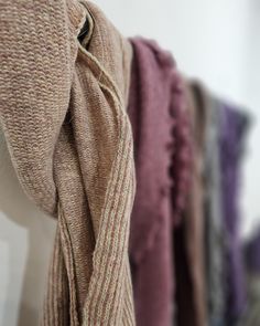 a row of scarves hanging on a wall