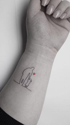 a woman's arm with a small tattoo on it