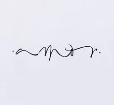 the word mom written in cursive writing on a white paper with black ink