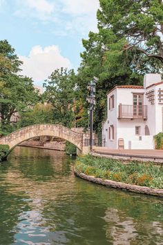 a small bridge over a river next to a building