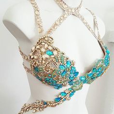 a mannequin with blue and gold jewelry on it