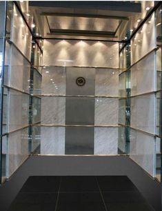 an empty display case with glass shelves and lights