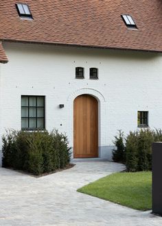 a white brick house with a wooden door