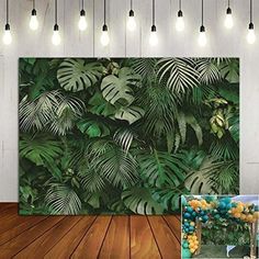 an image of a tropical themed party with balloons and greenery on the wall behind it