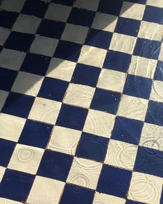 a black and white checkered tile floor with water running down it's sides