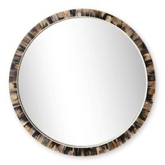 a round mirror with an animal print frame