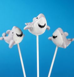 three toothpicks with fake sharks on them