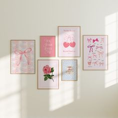 there are many pictures on the wall and one has a pink rose in front of it