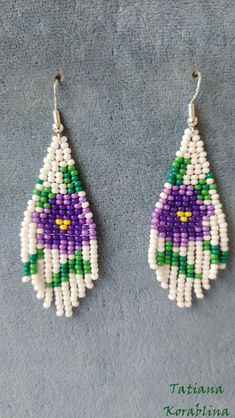 two pairs of beaded earrings with purple, green and white beads hanging from them