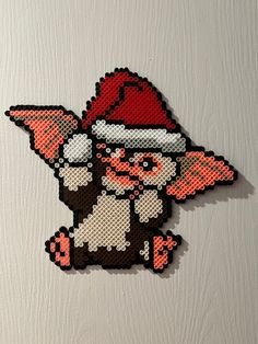 an image of a pixelated animal with a santa hat on it's head