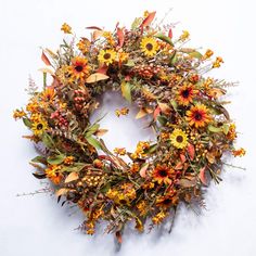 a wreath with sunflowers and other flowers on it